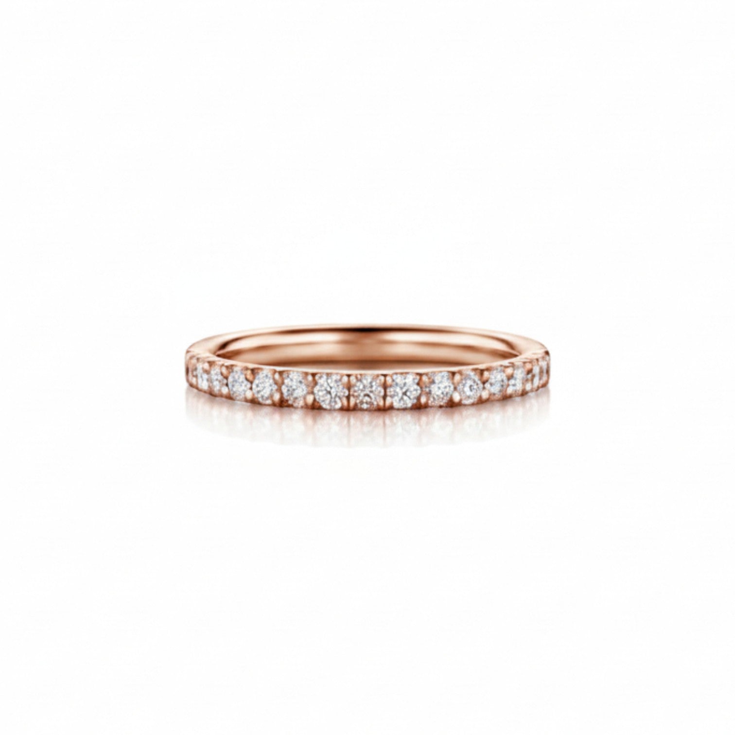 A classic pavé-set diamond wedding band in soft 18K rose gold — Diamond Ateliers.