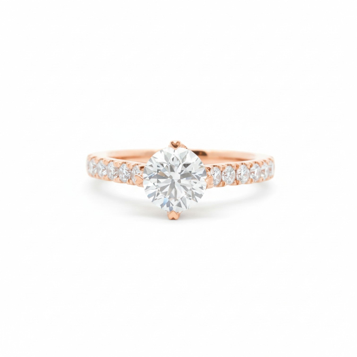 A pavé solitaire engagement ring with an NSEW setting and 4 heart prongs in 18K rose gold — Diamond Ateliers.