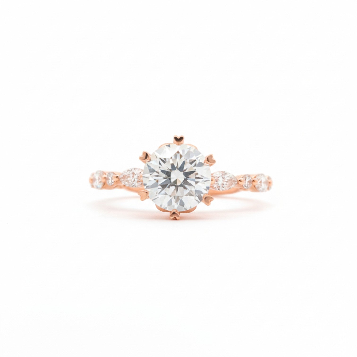 Round & marquise crown solitaire ring with six heart prongs in 18K rose gold – Diamond Ateliers.
