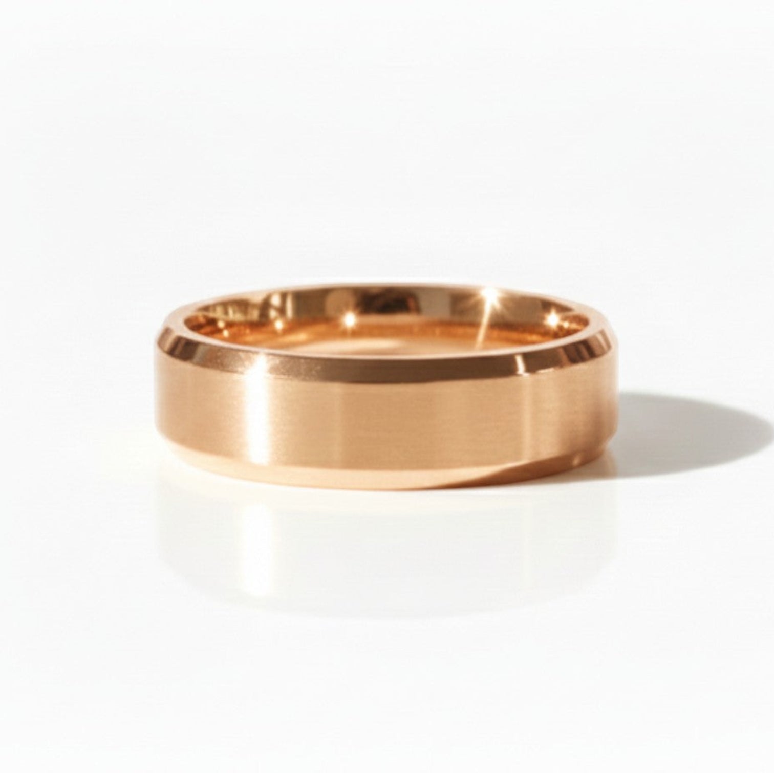 Matte finish 4mm bevel wedding band with clean edges, shown in rose gold on a minimal studio backdrop.