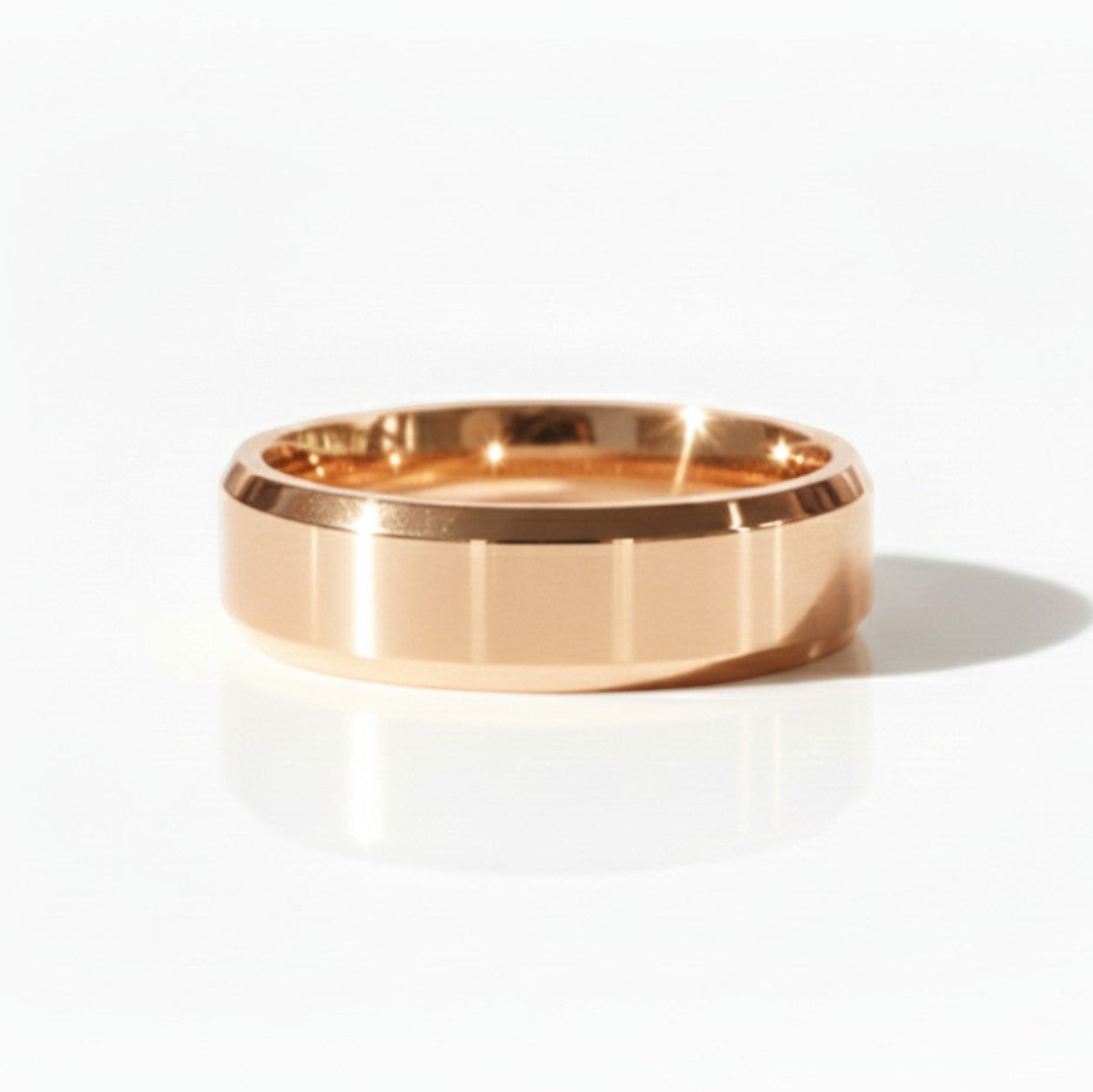 4mm high polish 18K rose gold wedding band on soft beige background