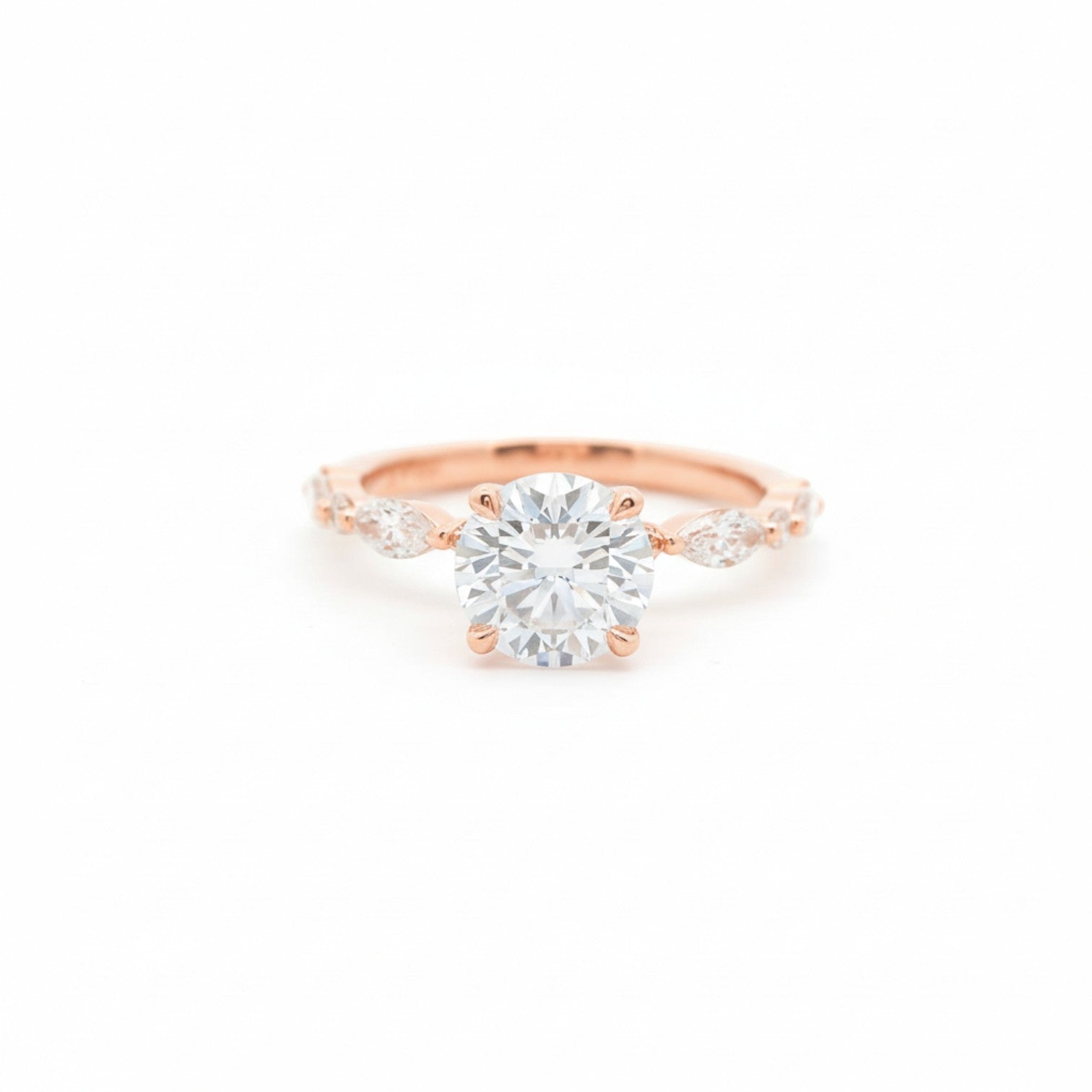 Marquise-inspired round solitaire engagement ring with four claw prongs in 18K rose gold – Diamond Ateliers.