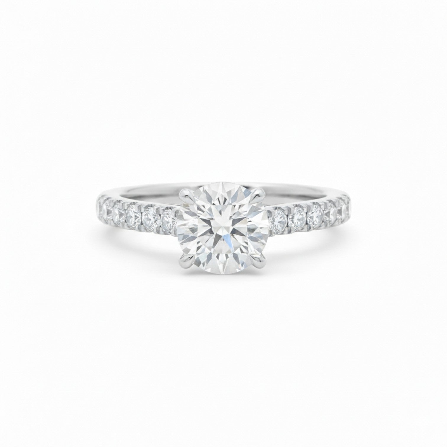 A four-prong claw pavé diamond engagement ring in polished 18K white gold — Diamond Ateliers.