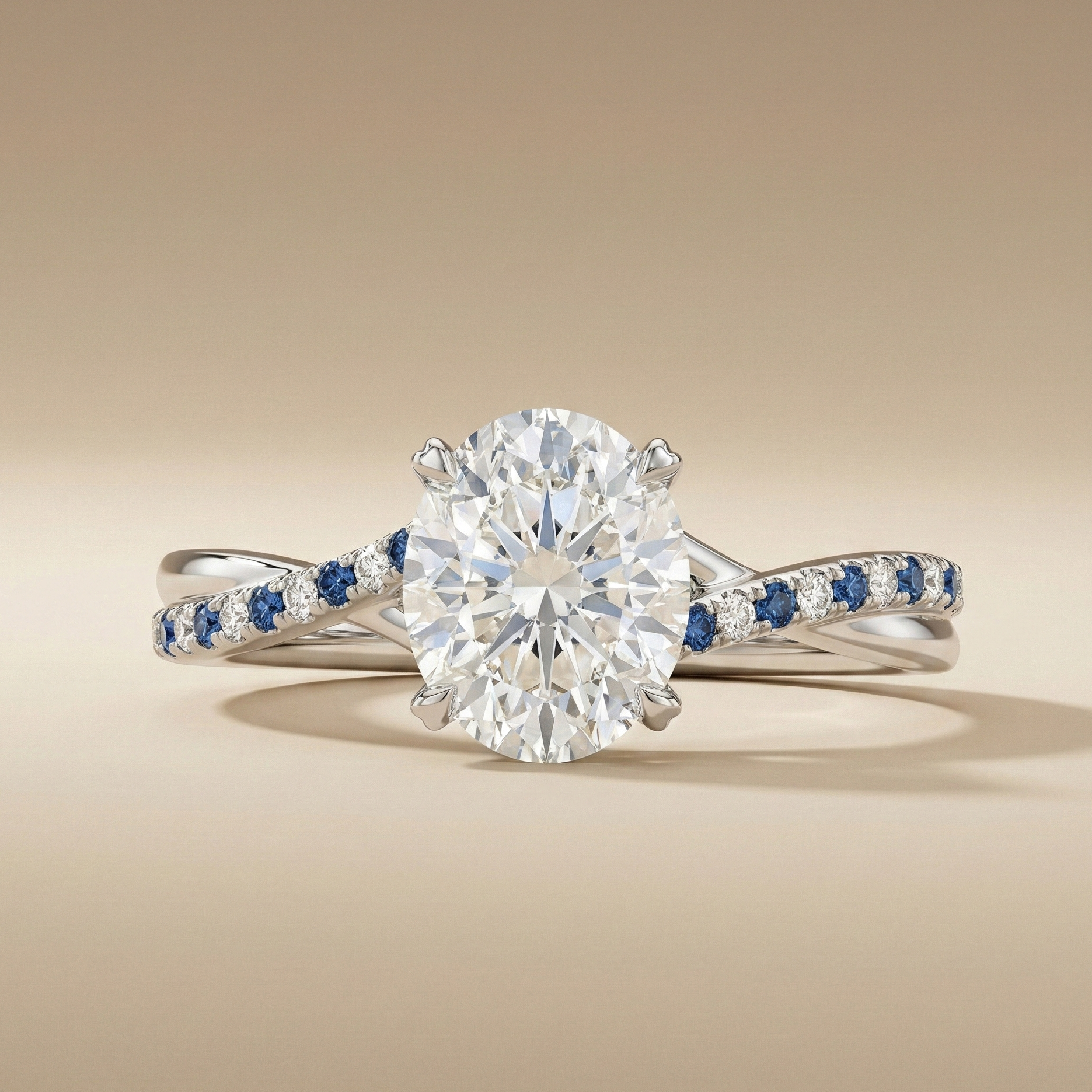 Platinum twist ring with an oval diamond and alternating blue sapphire and diamond pavé band on a beige background