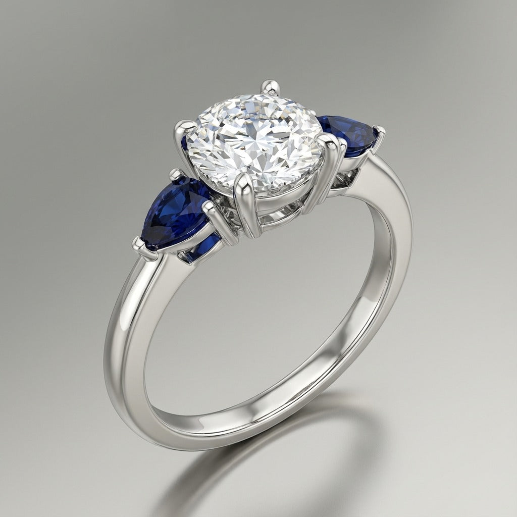 18K White Gold Round Trilogy Ring – Pear-Cut Blue Sapphires