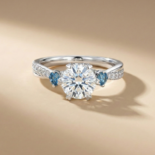 18K White Gold Twist Trilogy Ring with Blue Heart Diamonds - Image 1