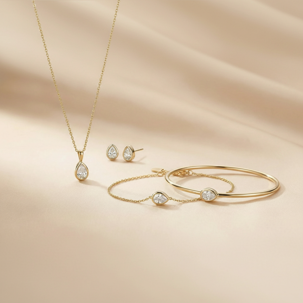 Gold jewelry set including necklace, earrings, and bracelets on a beige fabric background