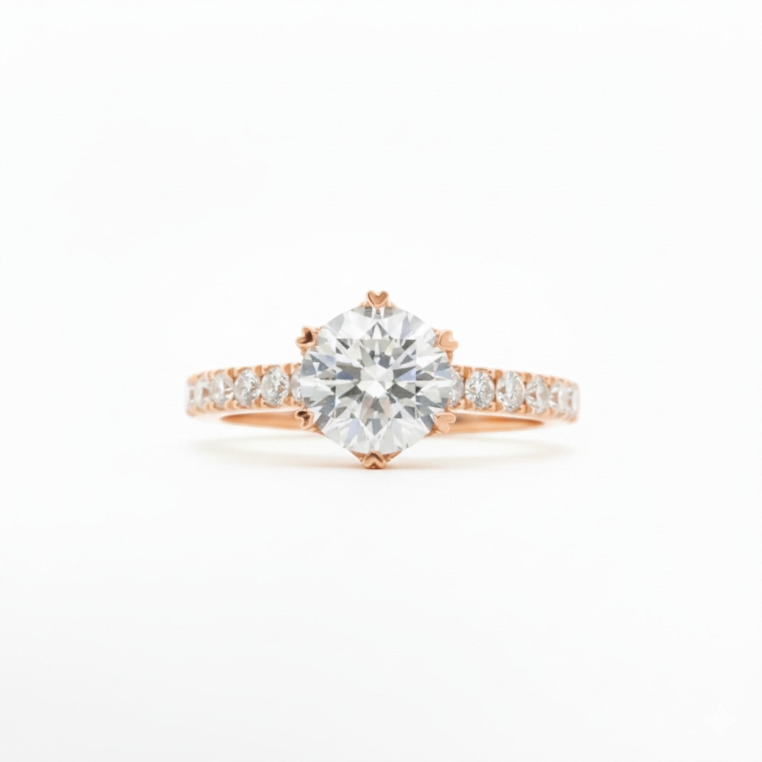 Six-heart-shaped prong pavé solitaire engagement ring in 18K rose gold with pavé band – Diamond Ateliers.