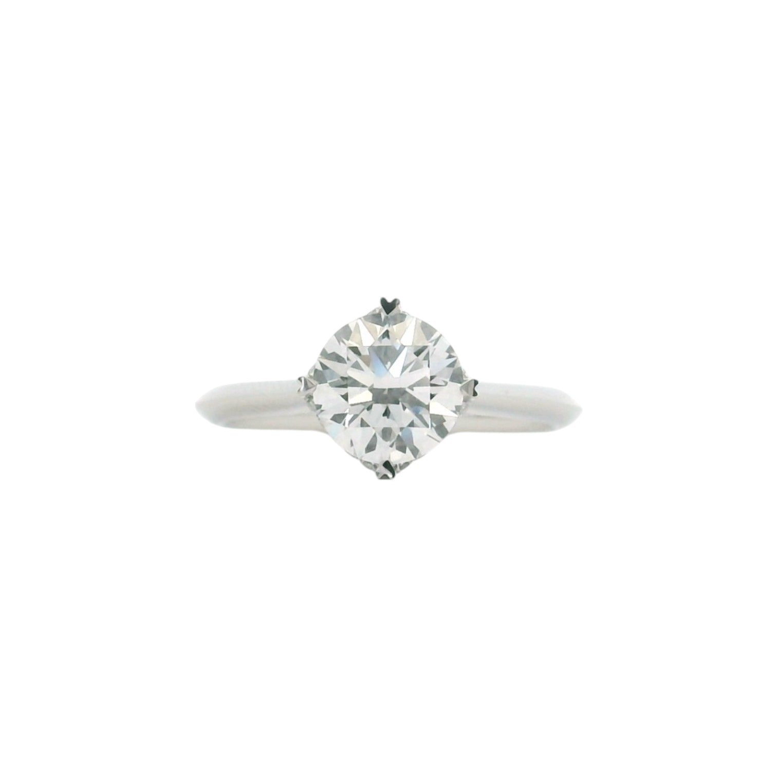 A NSEW solitaire engagement ring with 4 heart prongs in polished 18K white gold — Diamond Ateliers.