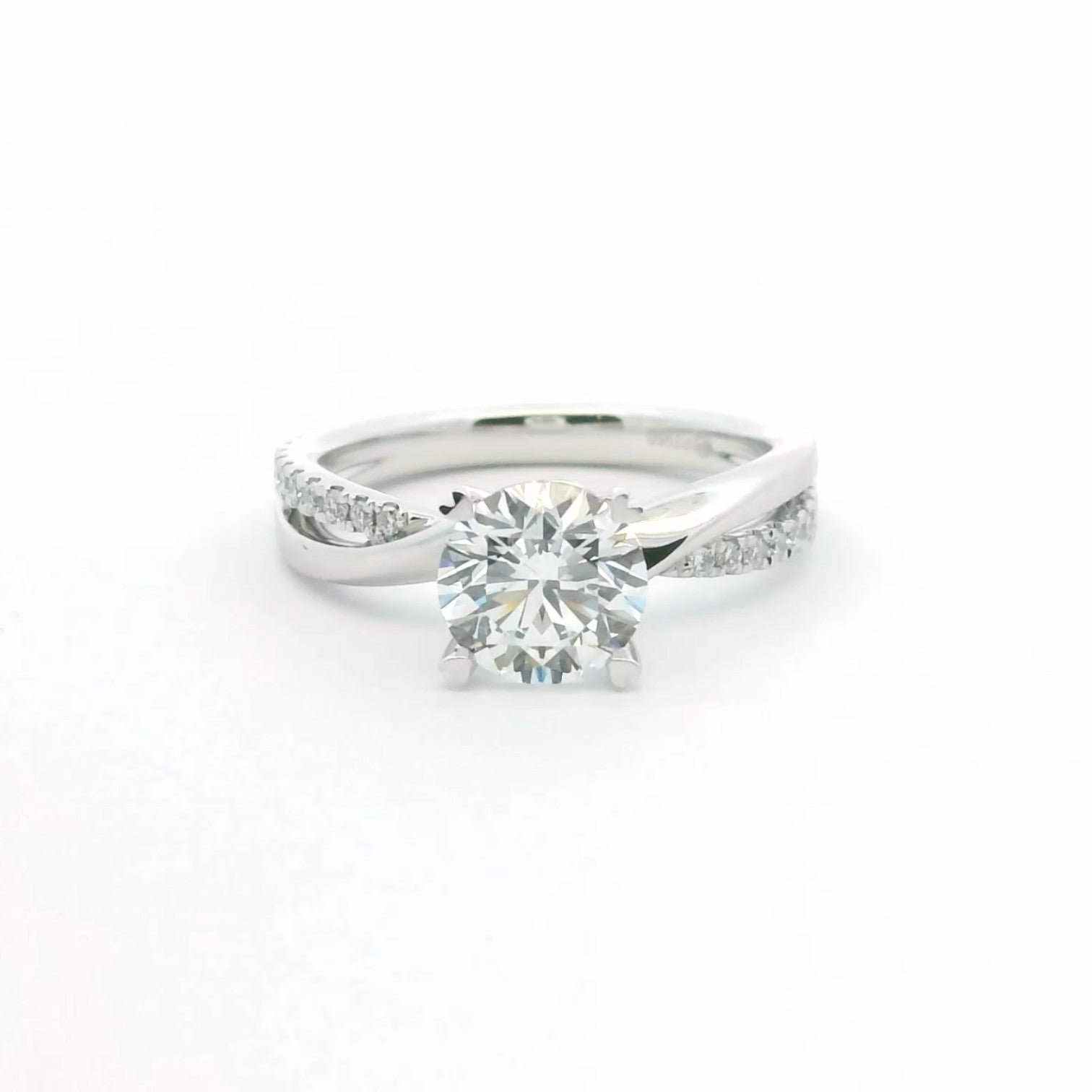 Open arc twist solitaire engagement ring with four heart-shaped prongs in 18K white gold – Diamond Ateliers.