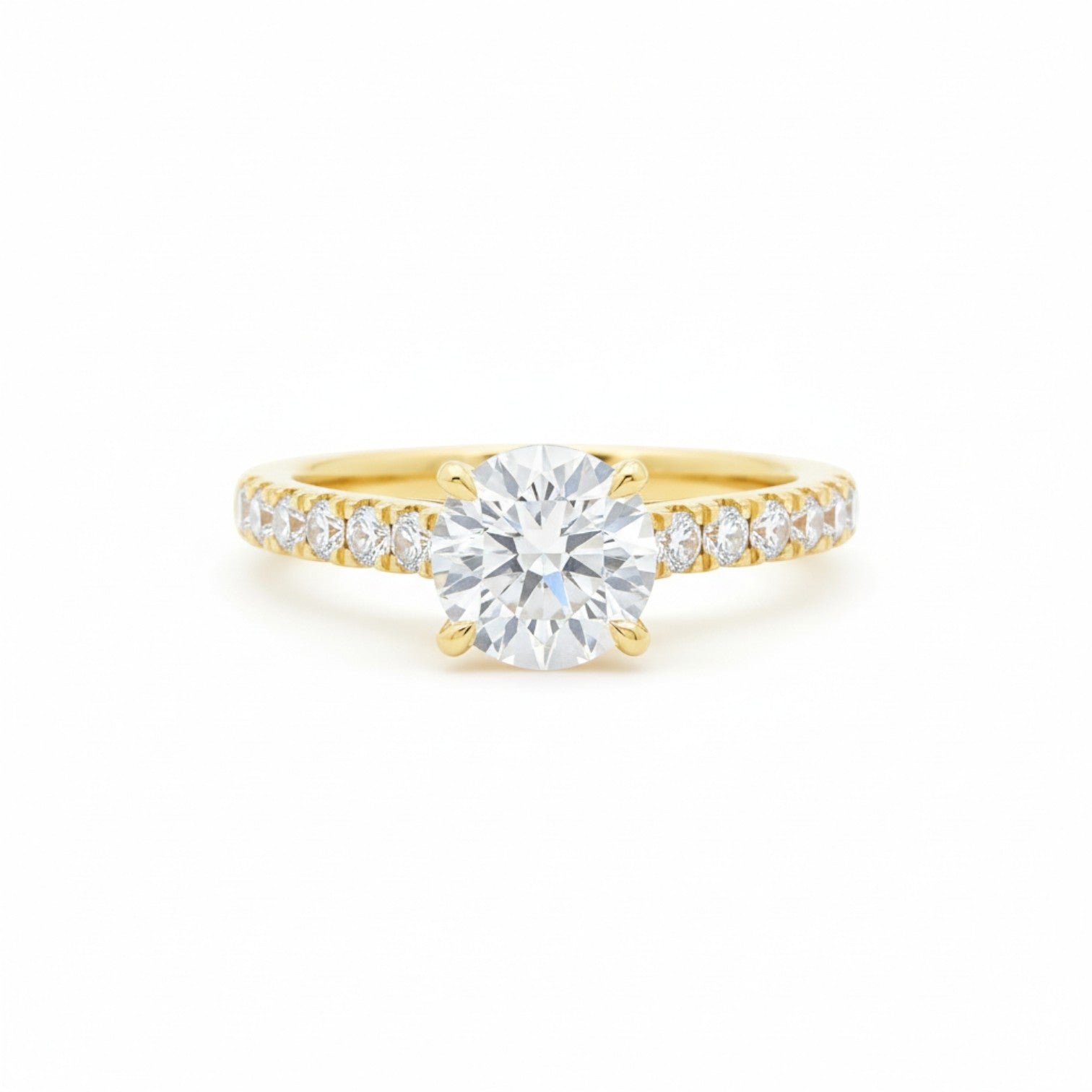 A four-prong claw pavé diamond engagement ring in classic 18K yellow gold — Diamond Ateliers.