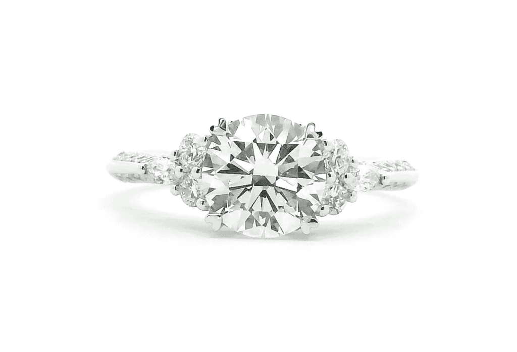 1.0ct diamond engagement ring with two round and two pear-shaped side stones in a bespoke trilogy design.