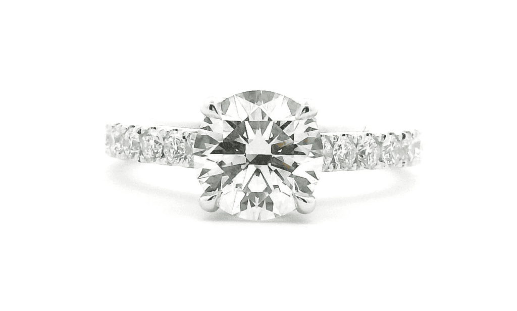 Round diamond engagement ring with a pave band in white gold