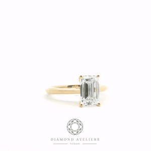 Yellow gold engagement ring with a 1.5ct emerald-cut lab diamond.