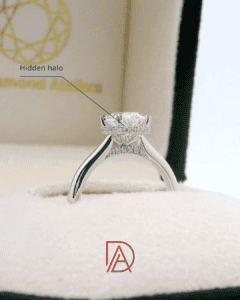 Side view of an oval diamond engagement ring showcasing a hidden halo of accent diamonds